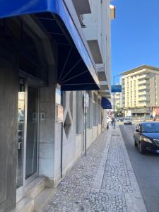 a car parked on a street next to a building at Rio Maior Hotel in Rio Maior