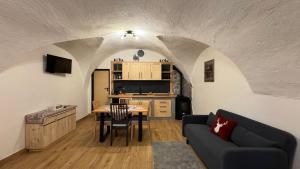 a living room with a couch and a table at Coriva Homes - Cogolo Stube in Cogolo