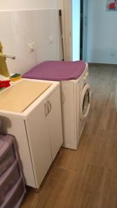 a washer and dryer in a room at Villa Saint George in Scopello