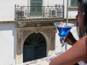 a woman holding a wine glass in front of a building at La Stella di Keplero in Cannole