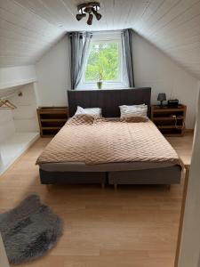 a bedroom with a large bed in a attic at Lägenhet i Kosta in Kosta