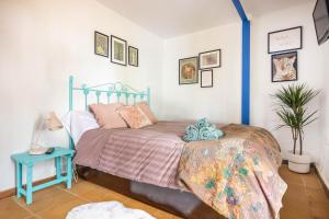 a bedroom with a bed and a potted plant at Cottage with Jacuzzi, Sierra Norte, close to Seville in Guillena