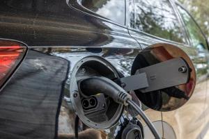 an electric car with a charger plugged into it at Cottage with Jacuzzi, Sierra Norte, close to Seville in Guillena