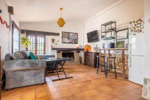 a living room with a couch and a table at Cottage with Jacuzzi, Sierra Norte, close to Seville in Guillena
