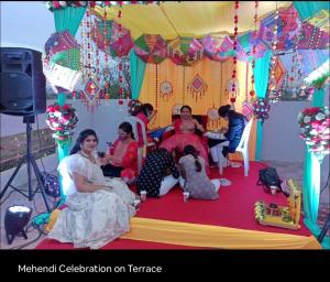 a group of people sitting on a bed in a tent at Hide away stay in Pune