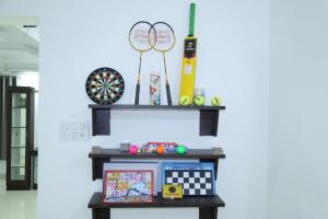 a shelf with a table with toys on it at Hide away stay in Pune