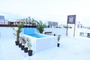 a swimming pool on the roof of a building with plants at Hide away stay in Pune