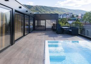 a house with a swimming pool on a roof at Concept14/16 in Tbilisi City