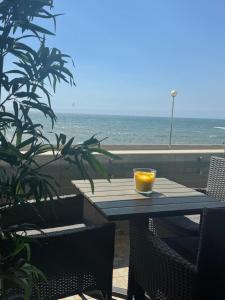 a table with a glass of orange on top of it at Aver Beach Haven in Póvoa de Varzim