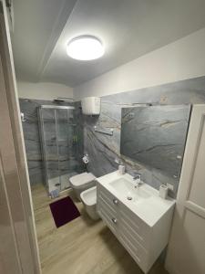 a bathroom with a sink and a toilet and a shower at Home Sweet Home in Foligno +58 photos