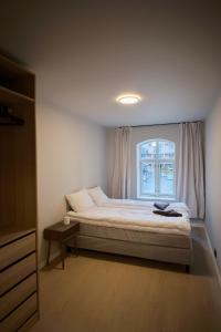 a bedroom with a bed and a window at Large city apartment with sea view and parking in Ålesund