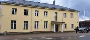 a large yellow building on the side of a street at ATB9 Guest House in Valga