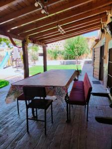 a wooden table and chairs on a patio at El Rincón de Arabayona in Arabayona