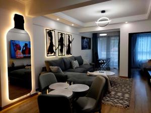 a living room with a couch and a table at Luxurious Condo with Rooftop Pool and Gym in Nairobi