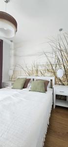 En eller flere senge i et værelse på Złota Wydma - M&K Apartamenty