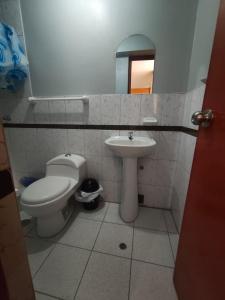 a bathroom with a toilet and a sink at Posada de Zarita in Chivay