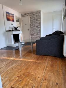 a living room with a couch and a glass table at Naturnära boende i Kosta in Kosta +1 photo