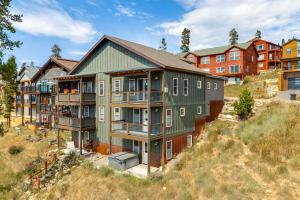 an apartment building on top of a hill at Home with Hot Tub and Views - Free Bus to Winter Park in Fraser