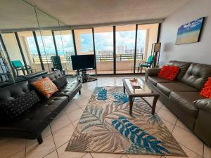 a living room with a couch and a table in a room at Beach condo with great views for your worry free vacation in Hollywood FL in Hollywood
