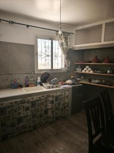 a kitchen with a sink and a window at Dar ifoulki in Wassane +13 photos