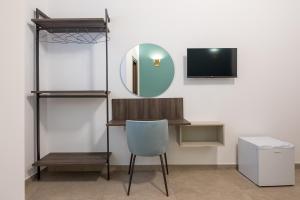 a room with a desk and a chair and a mirror at Terrazze Belvedere B&B in Favara