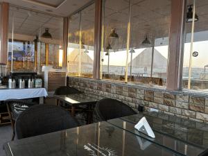 a restaurant with tables and chairs and a view of the pyramids at Pyramids Nun INN in Cairo