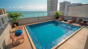 a swimming pool on the roof of a building at Hotel Diogo in Fortaleza