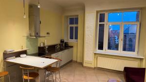 a kitchen with a table and some chairs in it at BestHomeRiga in Riga