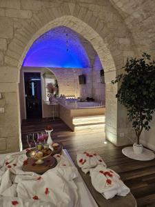 a room with a table with food and wine glasses at Romantic Suite with Private Jacuzzi Malely Suite in Martina Franca