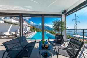 a view of the pool from the patio of a house at Apartments Villa Poco Loco in Mlini