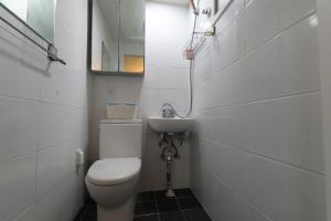 a bathroom with a toilet and a sink at GangNam Dream House in Seoul