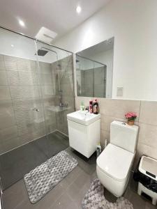 Un baño con ducha, inodoro y lavabo. en Loxwood House Apartments, en Accra
