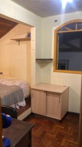 a room with a bed and a desk with a window at República Acrópole in Ouro Preto +11 photos