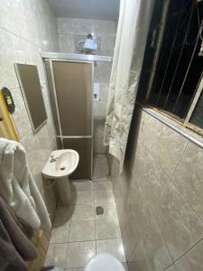 a bathroom with a shower and a toilet and a sink at República Acrópole in Ouro Preto