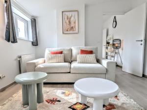 a living room with a couch and a stool at Casa Lairesse in Liège