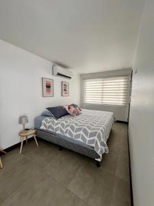 a bedroom with a bed in a room with a window at Modern Home with Private Pool - Selva Coral in Jaco - Just steps from the beach in Jacó +47 photos