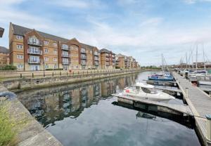 a group of boats docked in a marina with buildings at Hartlepool Marina View Apartment in Hartlepool