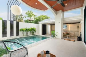 an indoor swimming pool in a house with a patio at At Bangla Patong Pool Moon villa in Patong Beach