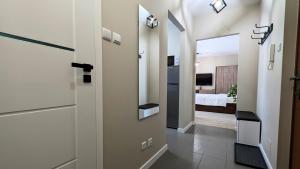 a hallway with a door leading to a bedroom at Ursus Pleasant Apartment by BookingHost in Warsaw
