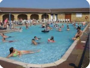 a group of people in a swimming pool at Happy Days Caravan Park - Lovely Spacious 3 Bed Caravan in Chapel Saint Leonards