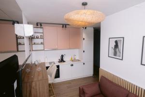 a kitchen with a dining table and a chandelier at Stan na dan "Aparté" Brčko in Brčko