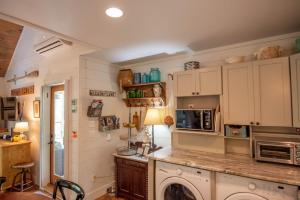 a kitchen with white cabinets and a microwave at Sweetwater Cottage - Private Cottage Tucked in the Woods - WJ & Boone - River Access in West Jefferson +16 photos