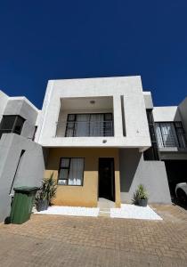 a large house with a driveway in front of it at Haven Hide Self Catering in Windhoek