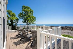 a balcony with chairs and a view of the ocean at The Tidepools - Home for 12 in York +51 photos