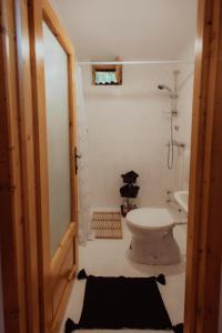 a bathroom with a toilet and a sink at Cheerful Forest Cabin with Hot Tub! 