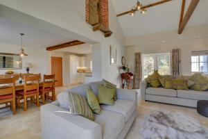 een woonkamer met een bank en een eetkamer bij Mill Cottage in Elsing