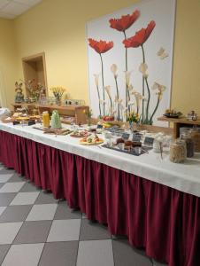 a long buffet table with food on it at Pension zum Reiterhof, Doppelbettzimmer in Schmogrow +31 photos