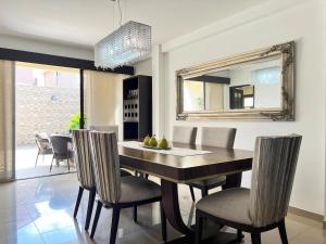 a dining room with a table with chairs and a mirror at Salinas Solutions in Salinas