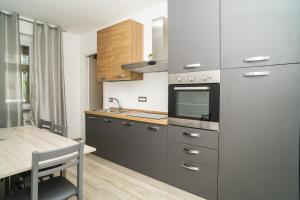 a kitchen with a sink and a stove top oven at IL BACIO Guest House - Affitti Brevi Italia in Perugia