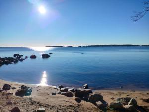 a large body of water with rocks in the water at Compact beautiful apartment with sauna in Kuusamo